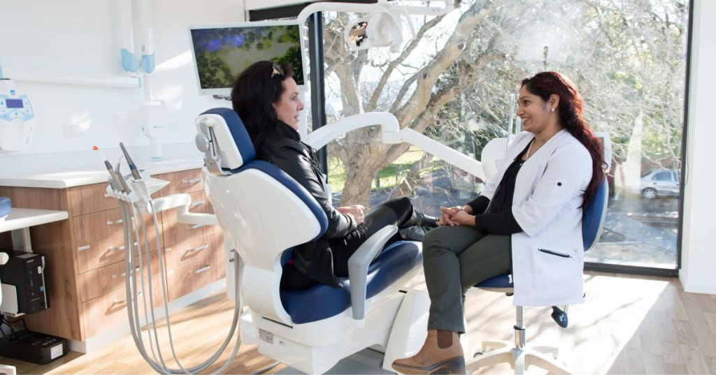 Dentist talking with a patient in a bright, purpose-built treatment room at Castletroy Dental Clinic