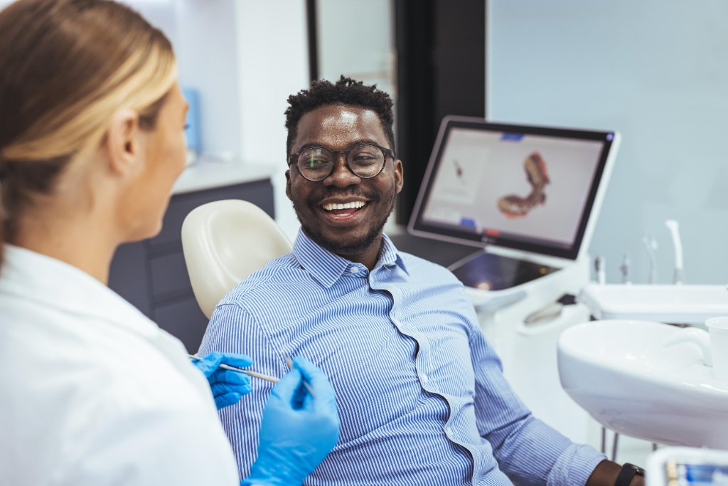 Smiling patient in the dental chair during a gentle routine check-up