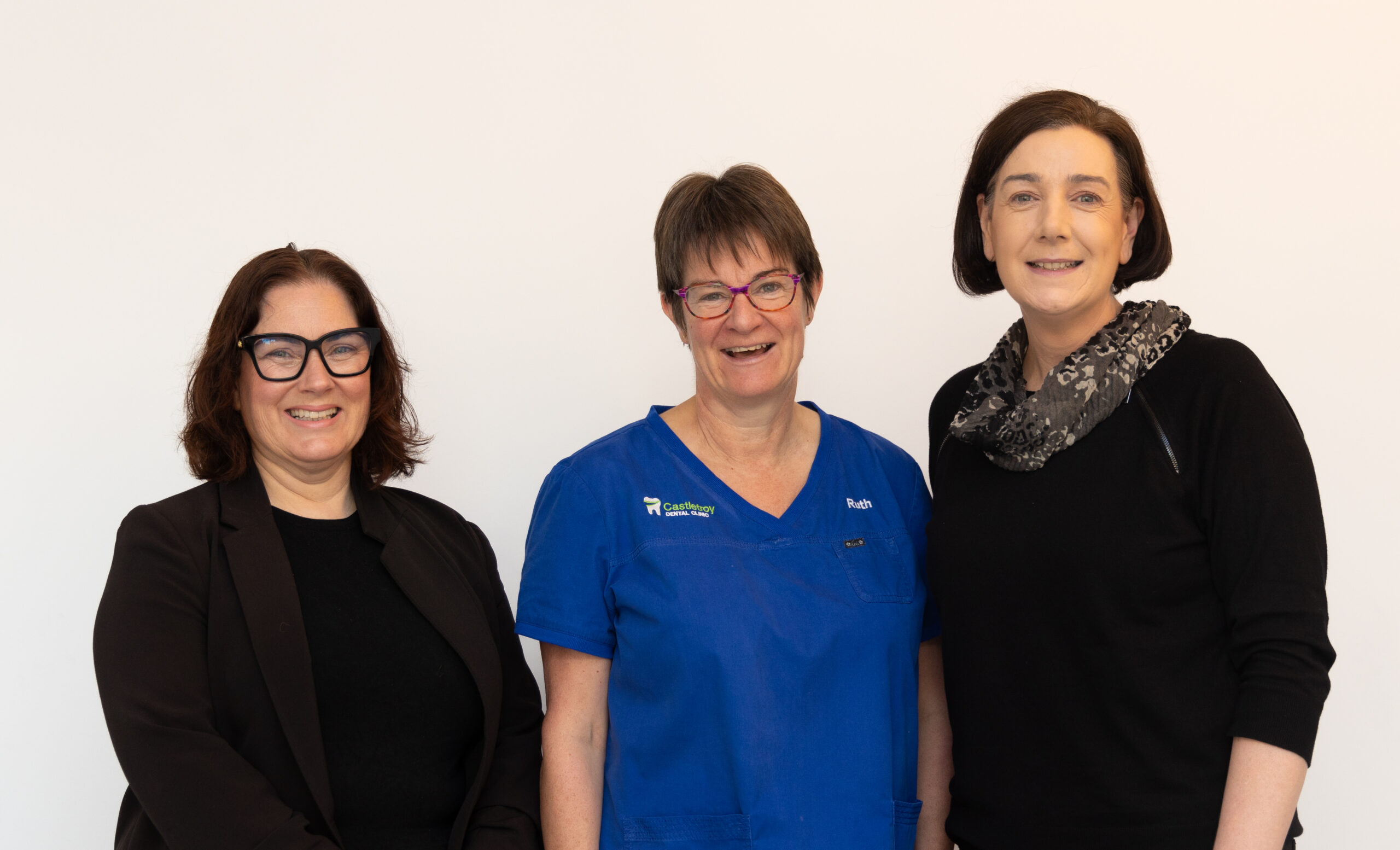 Three members of the Castletroy Dental Clinic practice team standing together at the clinic